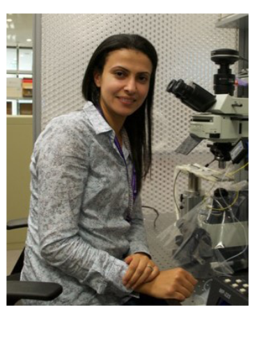 Basma Radwan posing next to a microscope