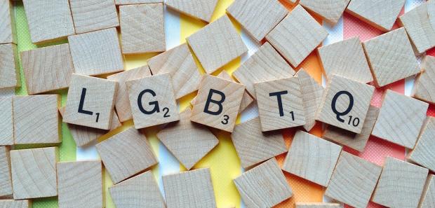 The letters LGBTG are spelled with scrabbles piece