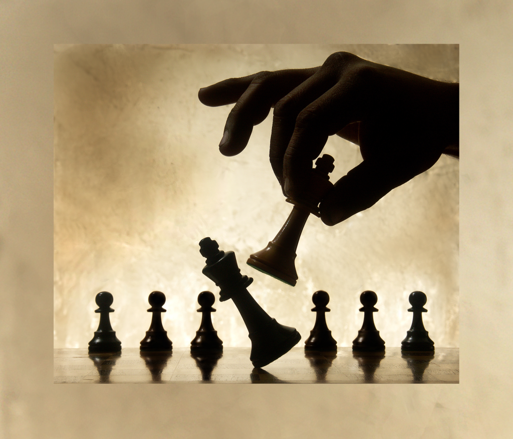 hand dropping a chess piece